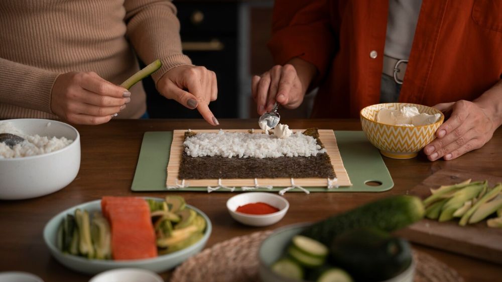 High angle women learning to make sushi